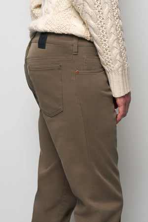 Brown pants worn by a person against a plain background